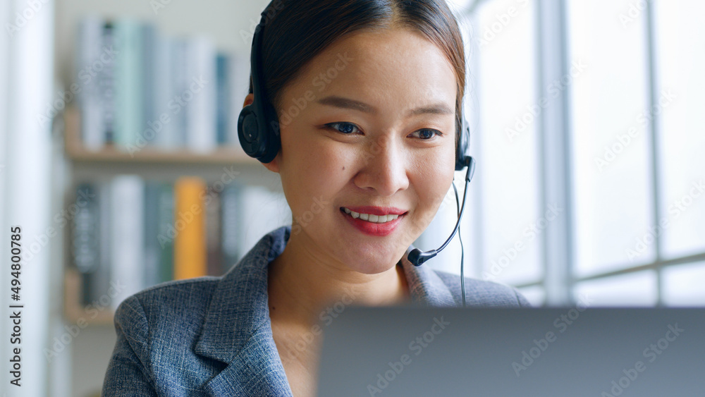 Close up of Young Asian businesswoman wearing headphone, call center, customer service talking on vi