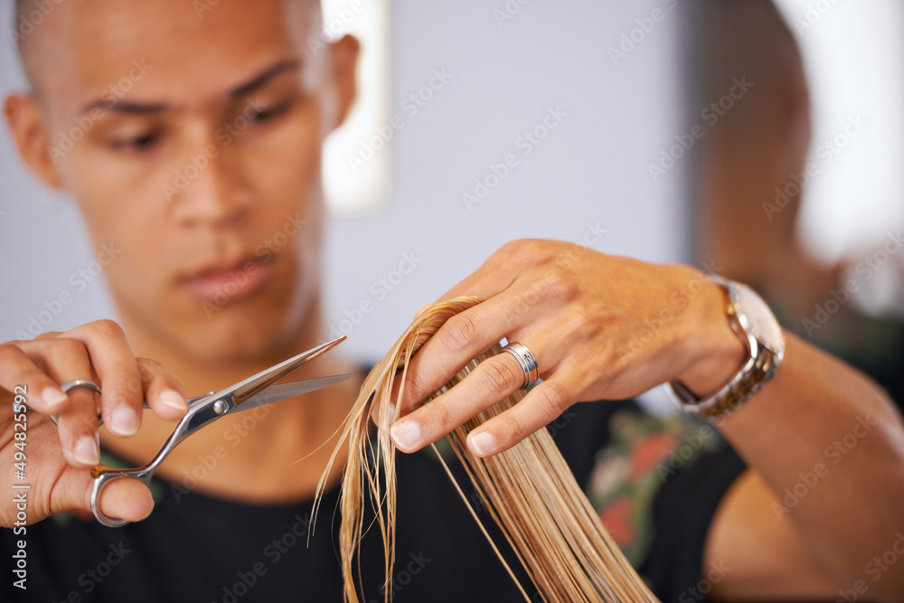 He knows his hair. Cropped shot of a male hairdresser cutting a clients hair.