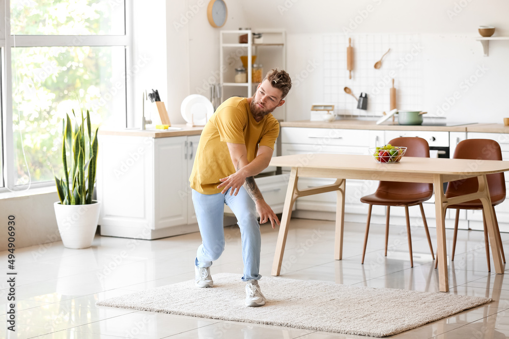 Cool young man dancing at home