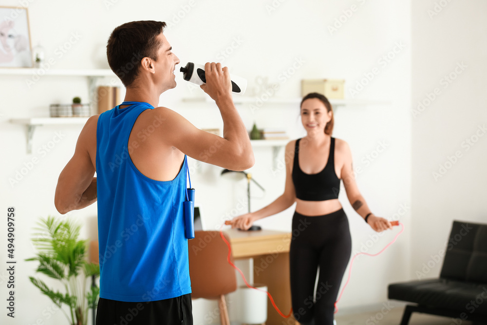 Sporty young couple training at home