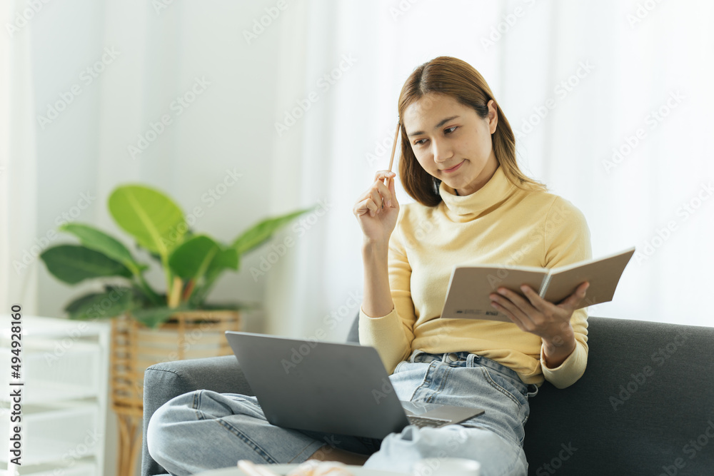 Online Education. Young Asian Girl Studying With Laptop At Home, Taking Notes While Watching Webinar