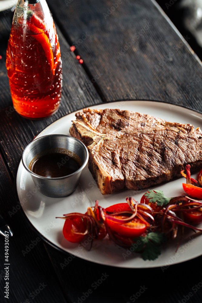 Grilled beef steak with pepper sauce and vegetable garnish