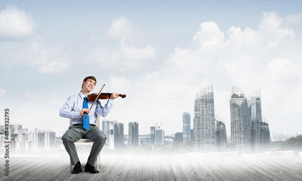 young businessman playing violin