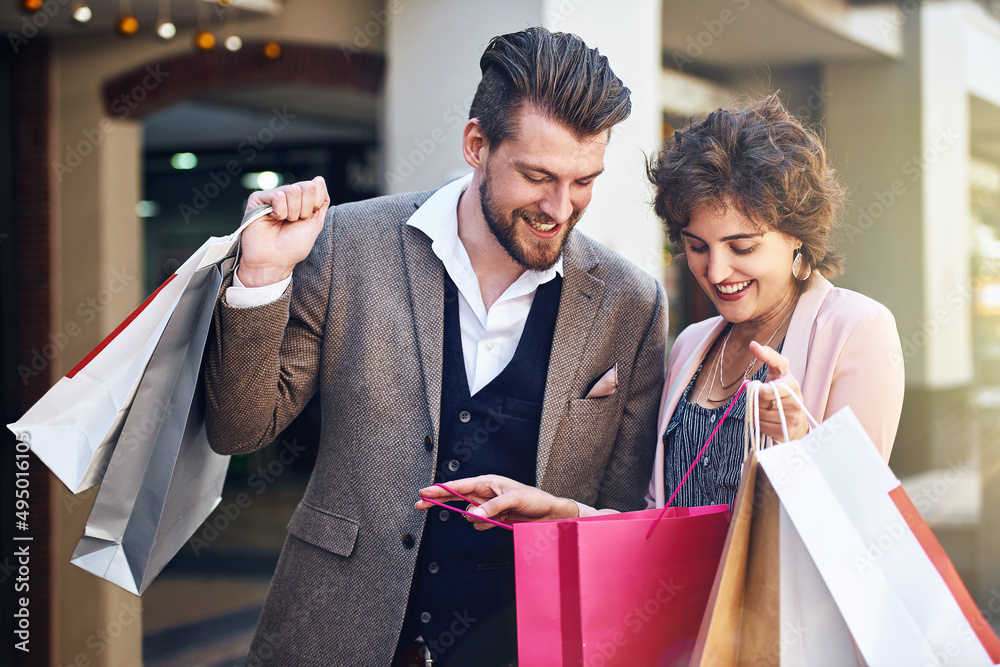 Look at all the items I got. Shot of a woman showing her boyfriend what she bought while out shoppin