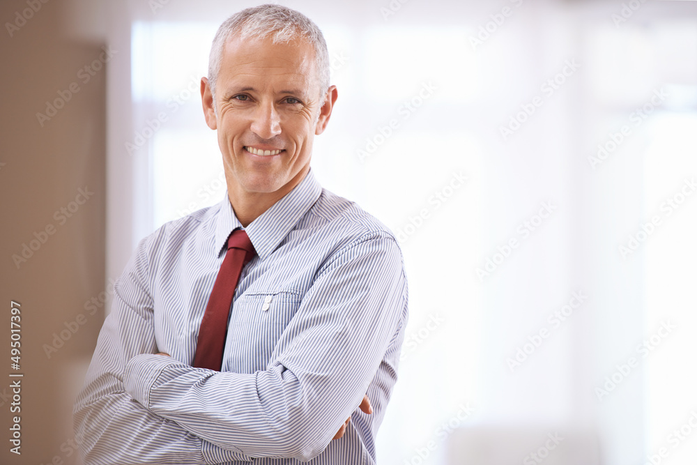 A smile you can trust. Portrait of a happy mature business man with his arms folded.