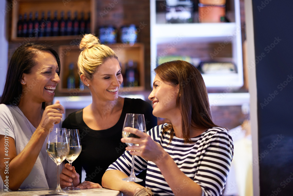 Shes a bit of a wine connoisseur. Cropped shot of three women enjoying a glass of white wine in a re