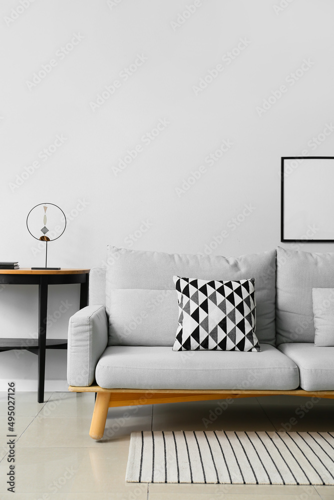 Interior of modern living room with stylish sofa, table and photo frame