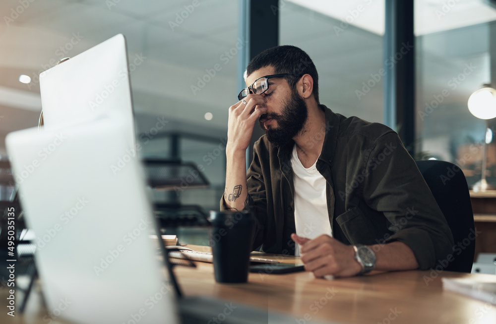 How many more nights of this can I take. Shot of a young businessman feeling stressed while working 