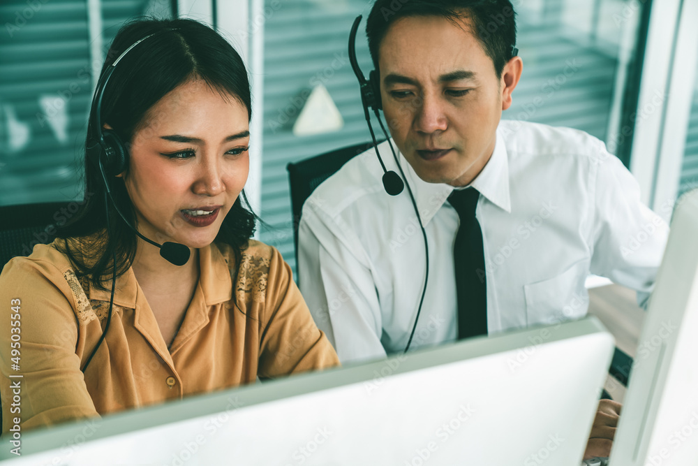 Business people wearing headset working actively in office . Call center, telemarketing, customer su