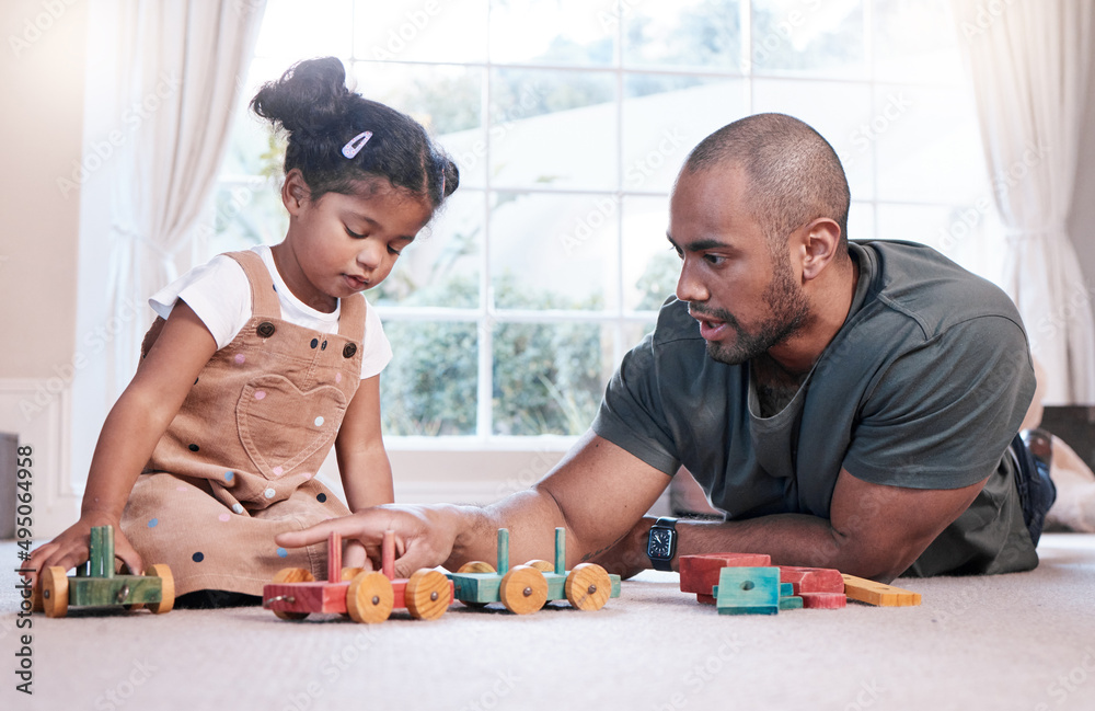 Lets build another choo-choo train. Shot of a father and his little daughter playing with wooden toy