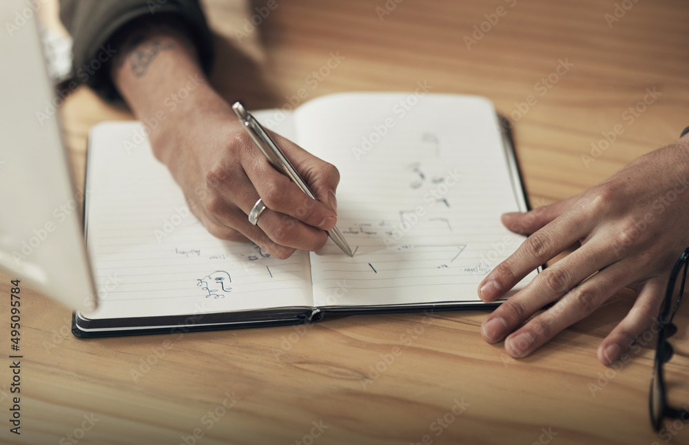 Take not of how the pro does it. Shot of an unrecognisable businessman writing in a notebook during 