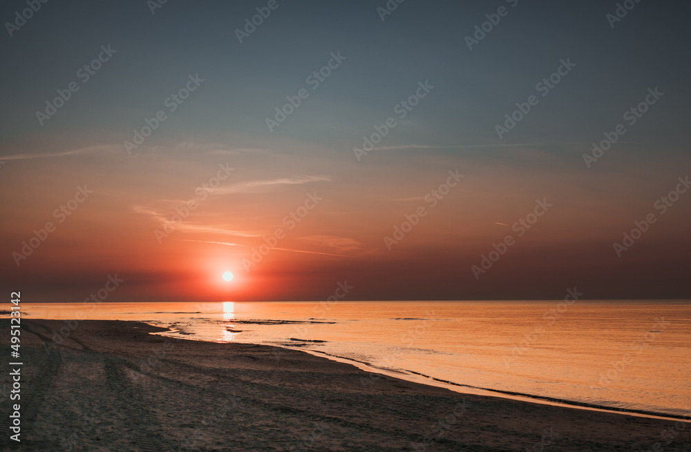 Clear sunset sky on sea shore with sandy beach