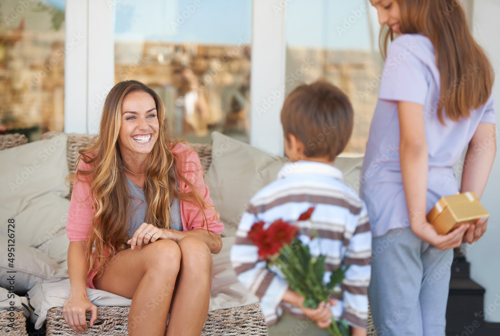 For the best mom ever. Shot of a mother and her two children holding gifts for mothers day.