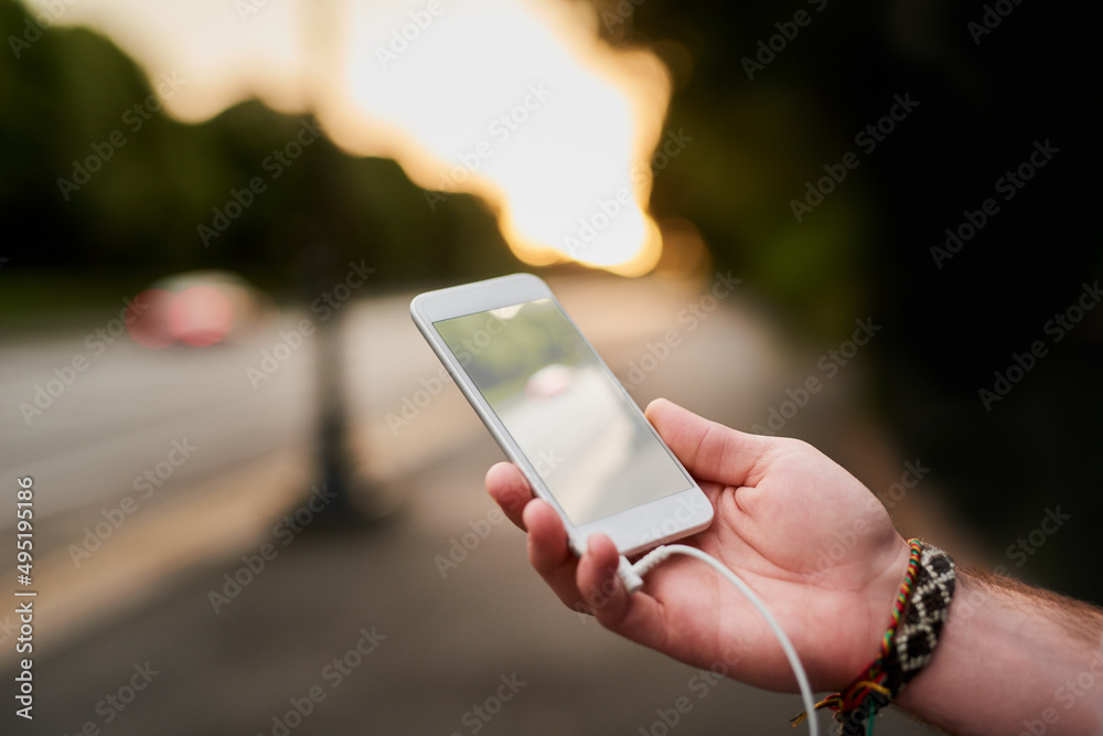 Music makes the best travel companion. High angle shot of a unrecognizable man listening to music on