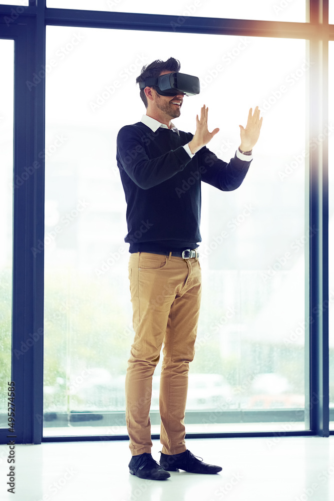 Reaching for a world of opportunity. Shot of a businessman wearing a VR headset in an office.