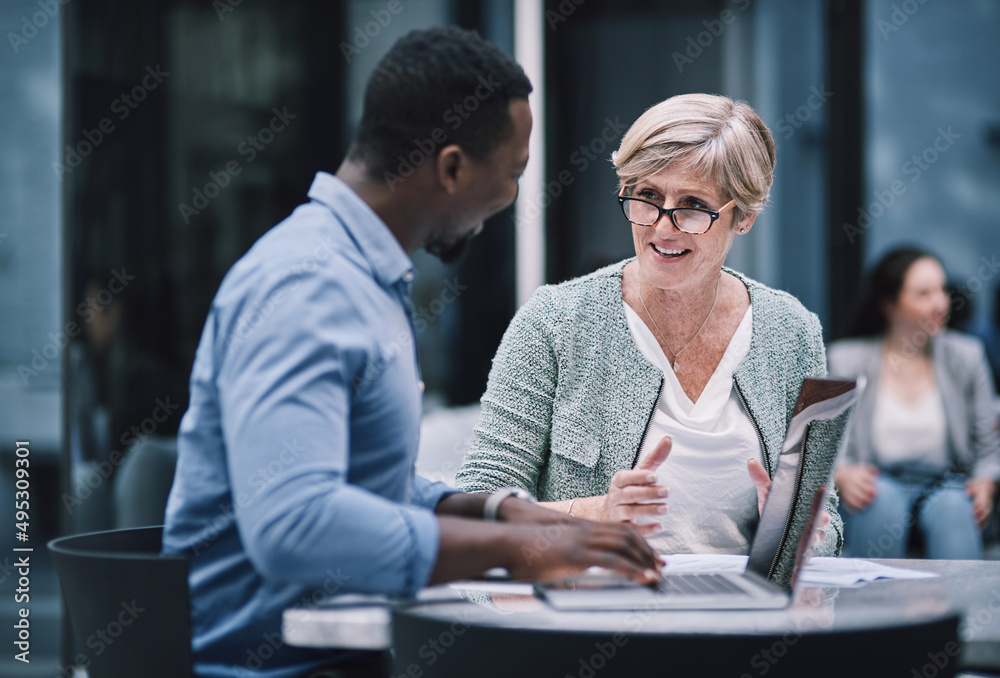 The team that has what it takes. Shot of a businessman and businesswoman using a laptop during a mee