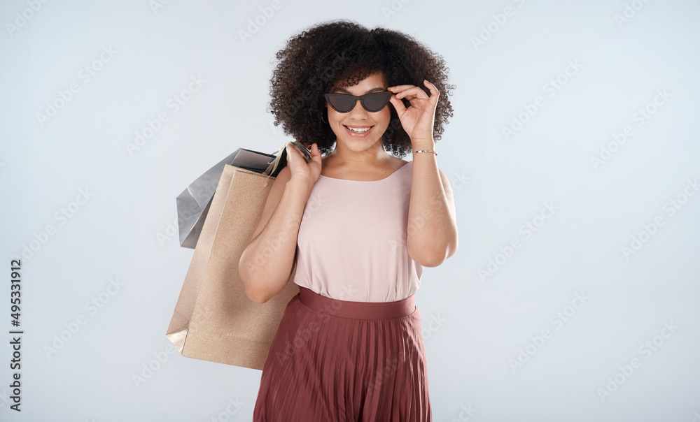 This is what a satisfied customer looks like. Studio portrait of an attractive young woman carrying 