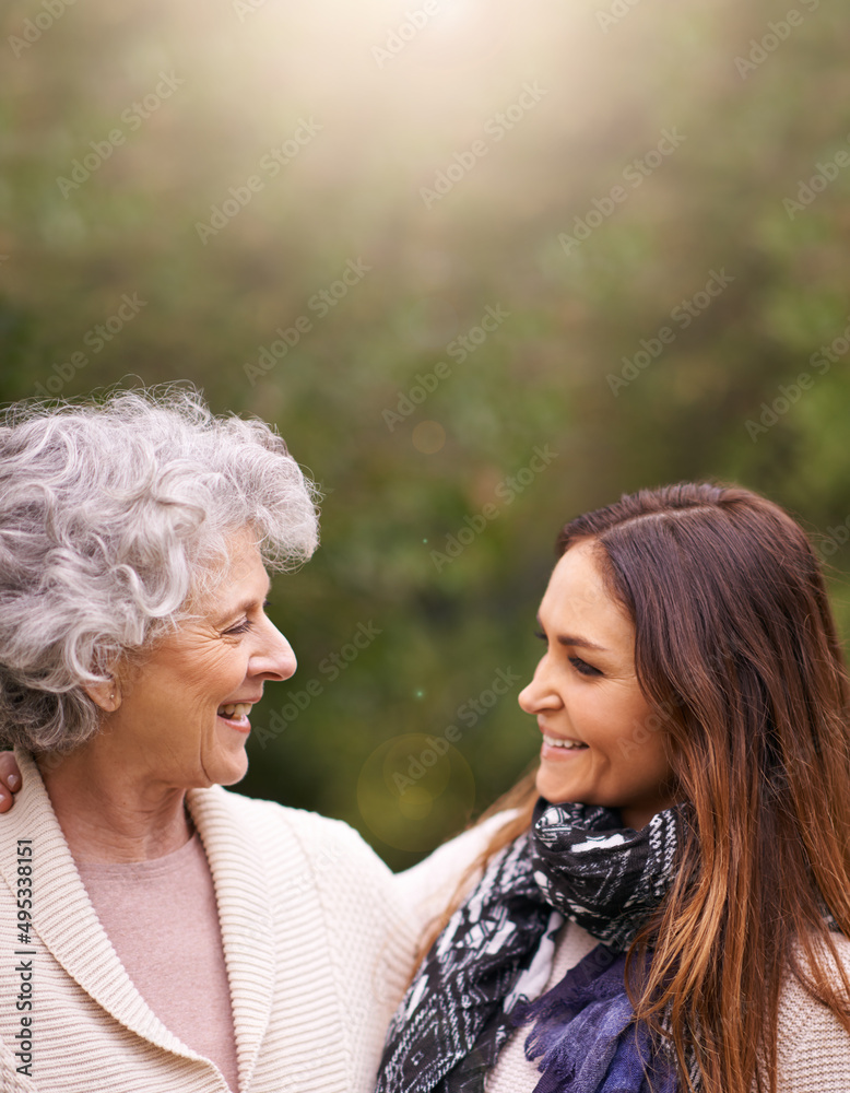 Catching up with mom. Shot of an attractive woman and her senior mother talking outside.