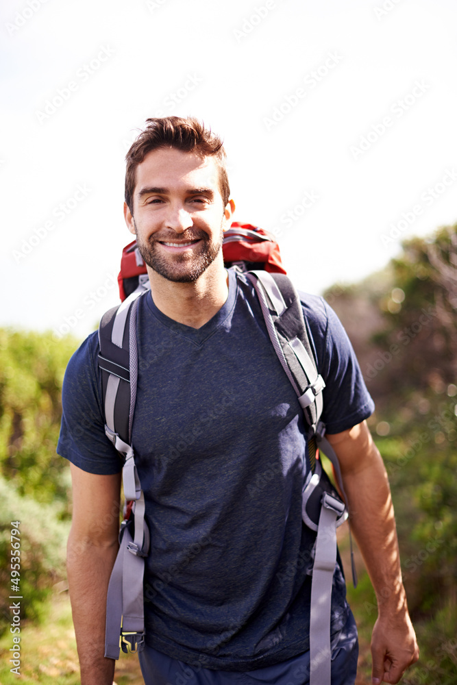 Go on, take a hike. Shot of a young man enjoying a hike through the mountains.