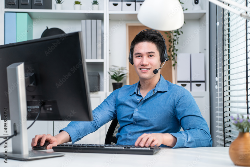 Portrait of Asian handsome business man sitting and working in office.