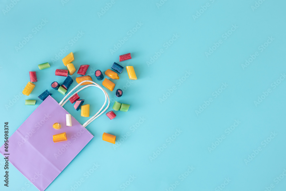 Flat lay, paper bag and chewing bags on a blue background.