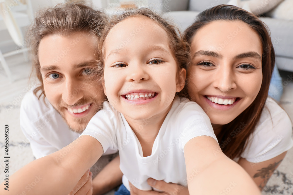 Happy young family taking selfie at home