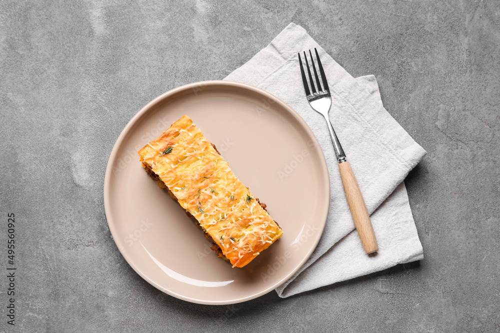 Plate with piece of tasty Shepherds pie on grey background