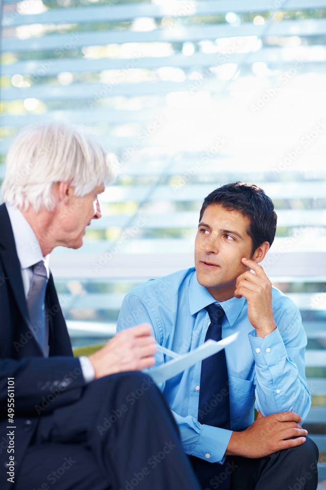 Contract issues. Portrait of good looking business men in discussion about contract at office.