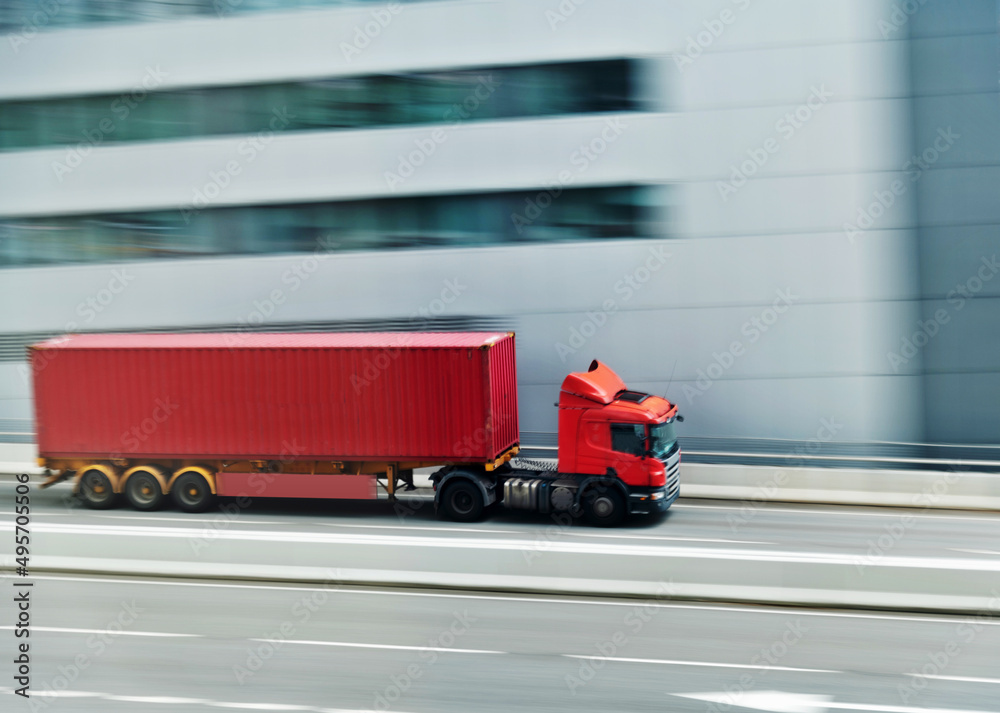 Container truck motion blur on highway overpass