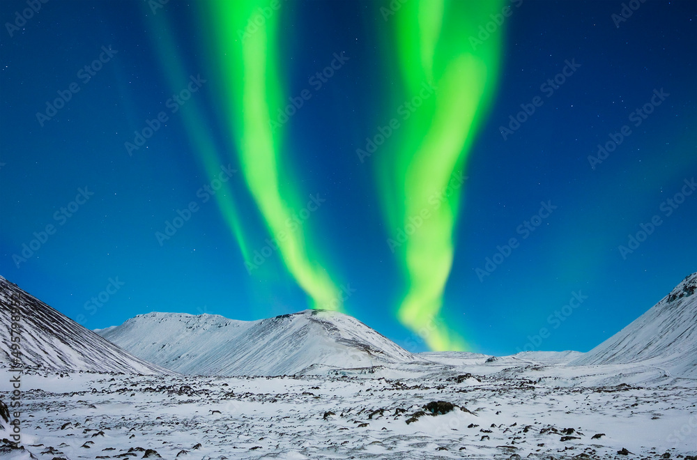 Nature. Aurora Borealis in Iceland. Northern Lights over the mountains. A winter night landscape wit