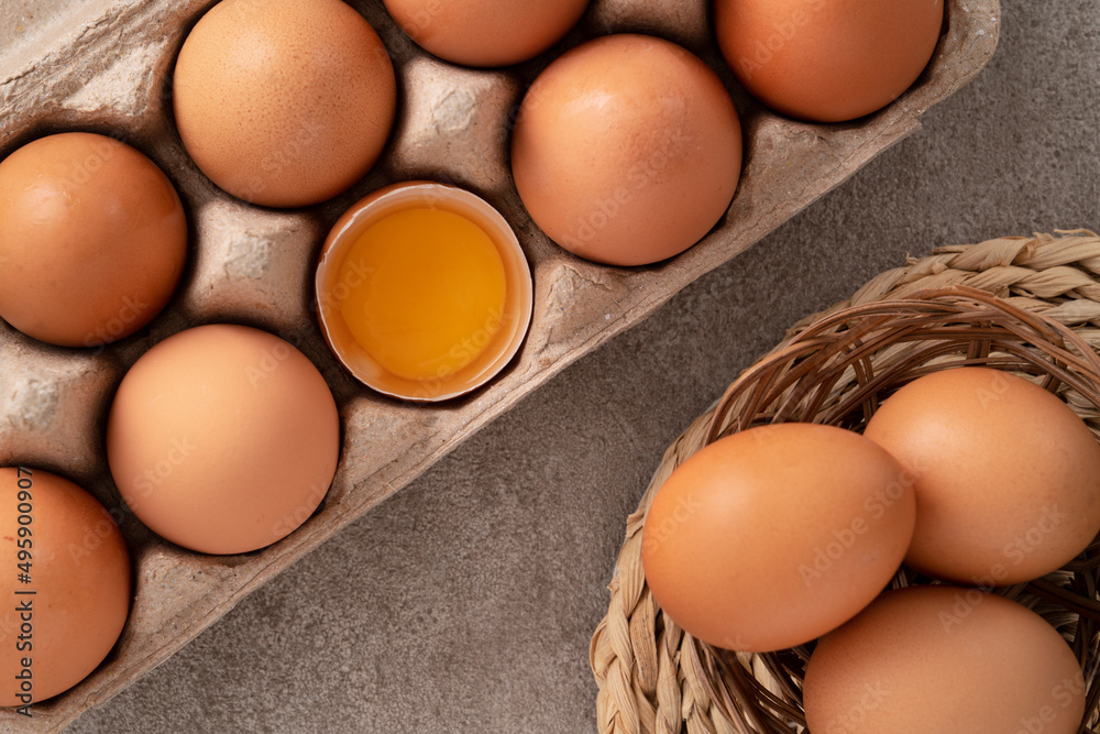 Fresh brown chicken eggs in a plate.