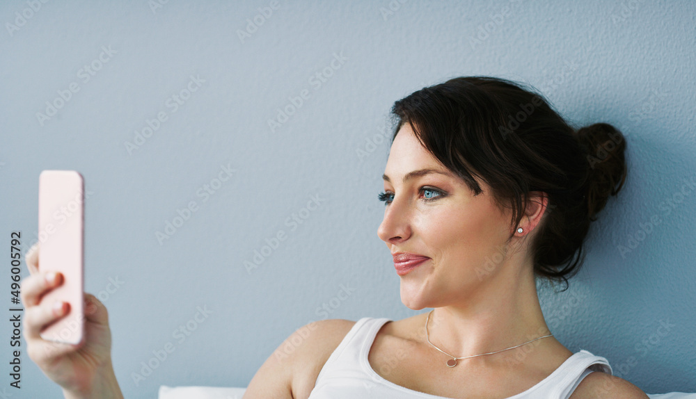 Be a fan of your own beauty. Cropped shot of an attractive young woman posing for a selfie in her be