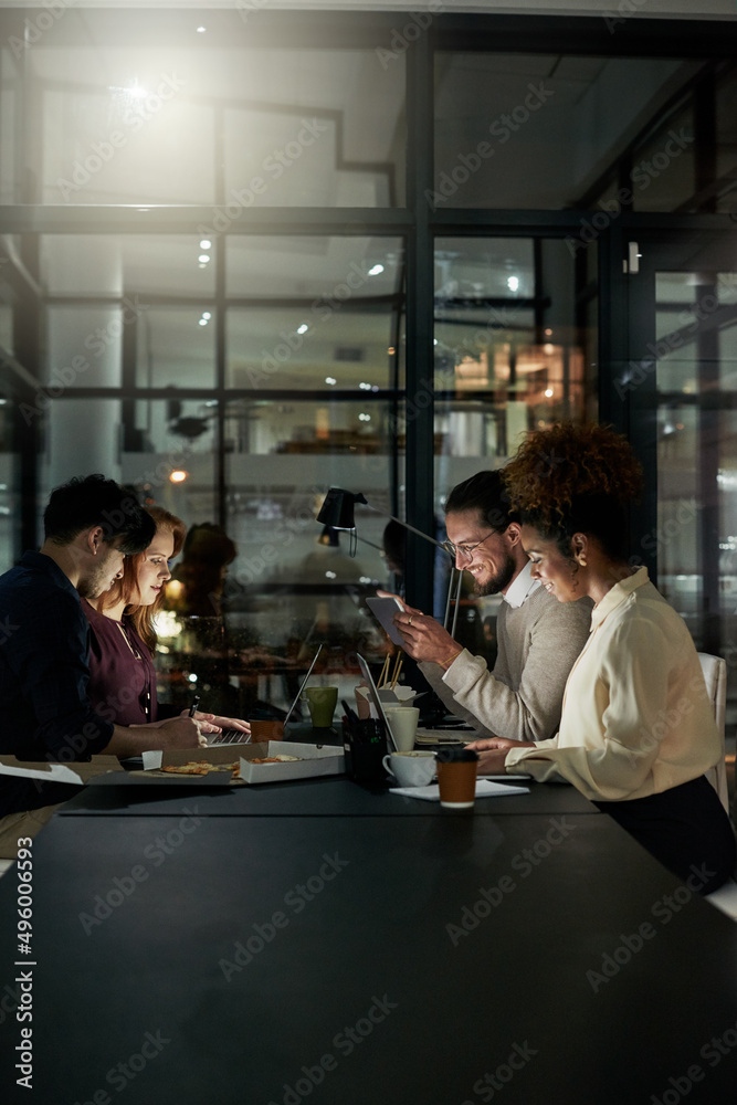 Many hands make light work. Shot of a group of young designers working late in the office.