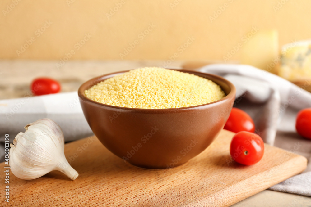 Bowl of raw couscous on table