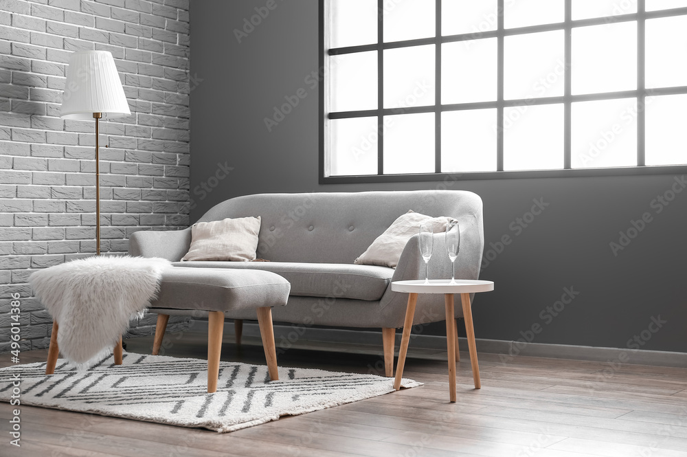 Empty glasses on table near sofa in living room