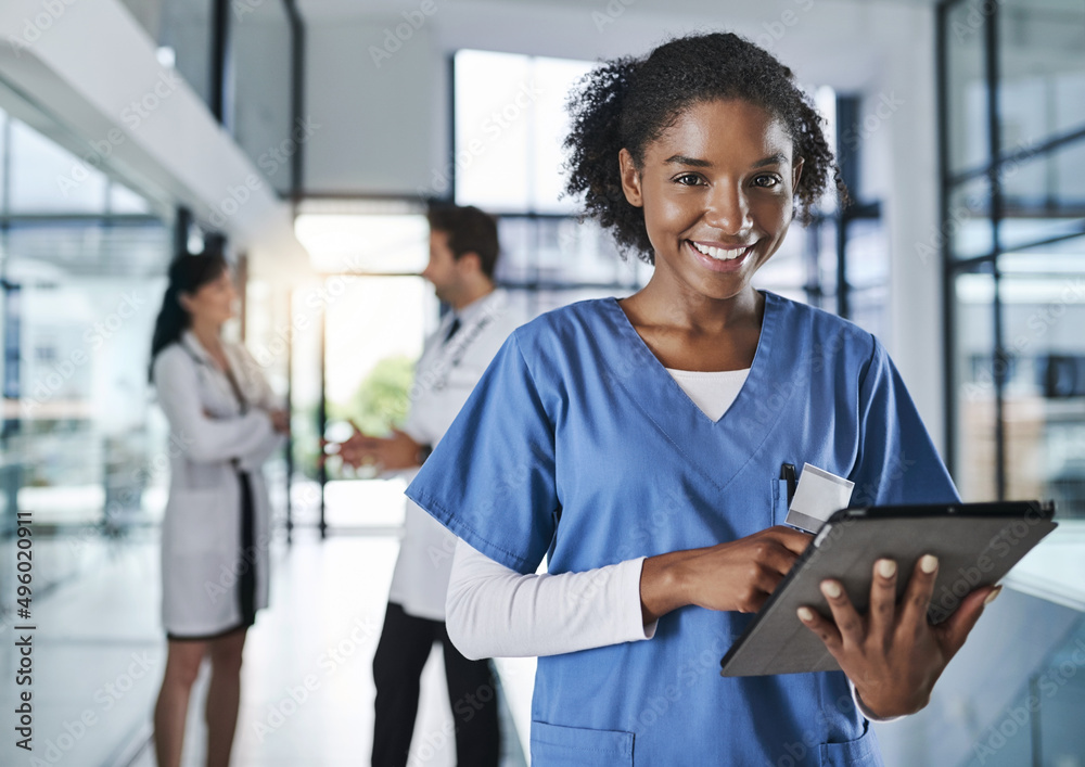 Our patient records are all digitized. Shot of a young doctor using a digital tablet in a hospital w