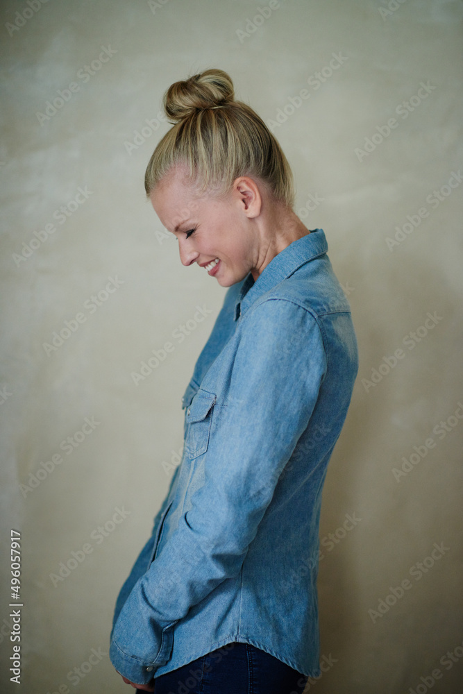 Hipster style. Studio shot of a young woman wearing a demin shirt.