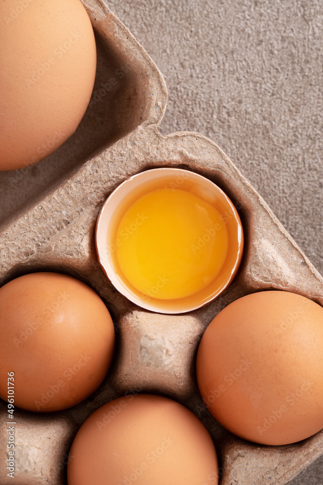 Fresh brown chicken eggs in a plate.