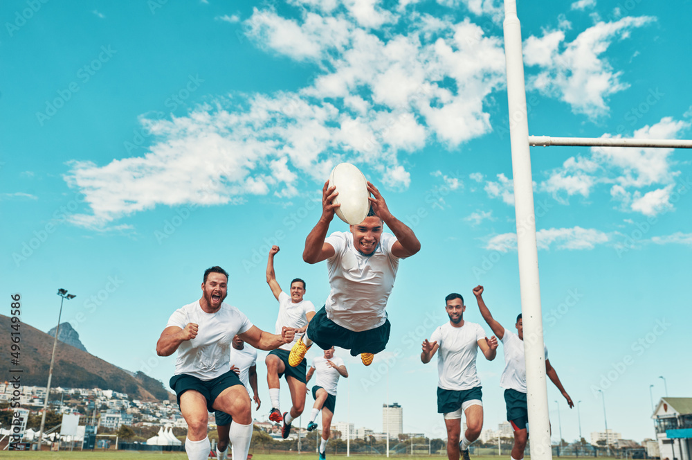 Hes the man of the match. Shot of a rugby player scoring a try while playing on a field.