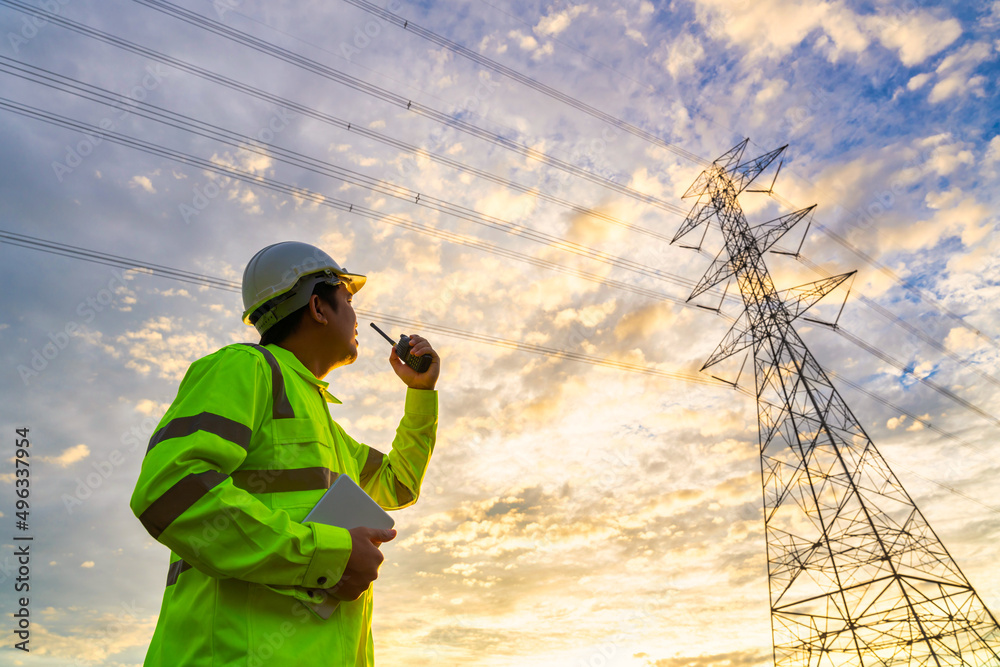 Asian engineer use radio checks at a power station for planning work by generating electricity from 