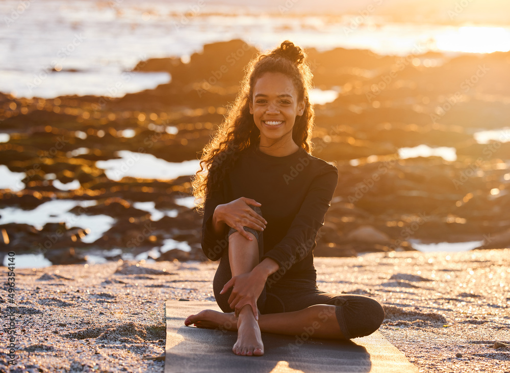 Happiness can only be found within. Shot of an attractive young woman sitting on her yoga mat during