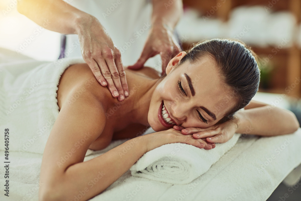 Massage does the body good. Shot of an attractive young woman getting massaged at a beauty spa.