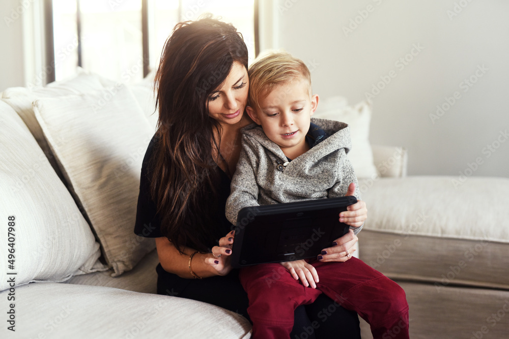 Lets see if we can find any cartoons. Shot of a carefree young woman browsing on a digital tablet wi