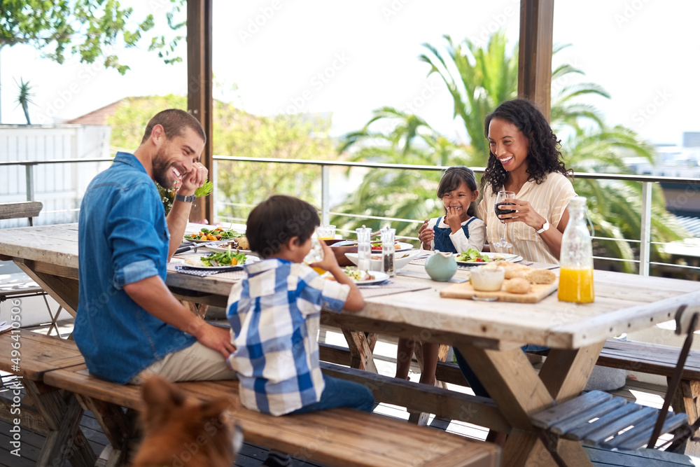 Meals always taste better when enjoyed with family. Shot of a beautiful young family enjoying themse