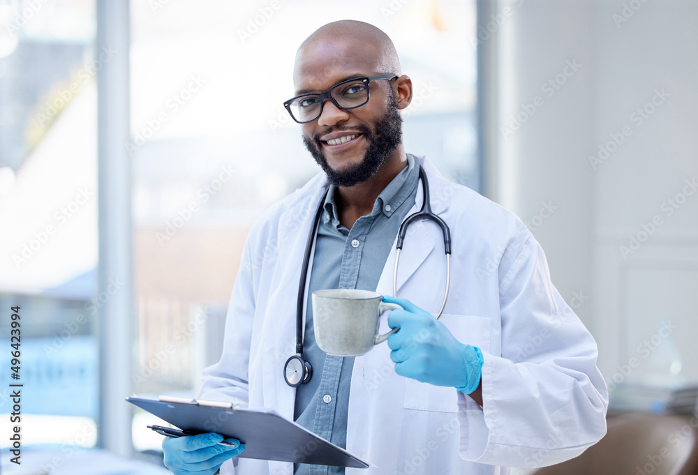 I have a passion for what I do. Shot of a male doctor holding a hot beverage and a clipboard.