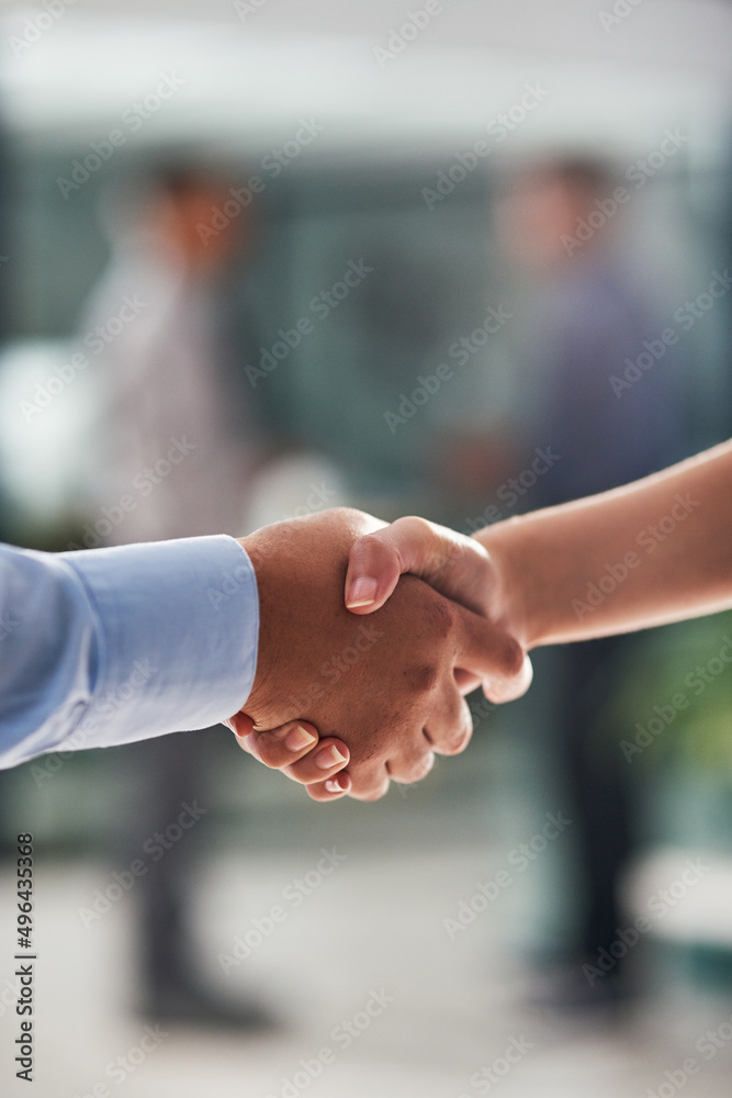 Sealing the deal with a handshake. Closeup shot of businesspeople shaking hands in an office.