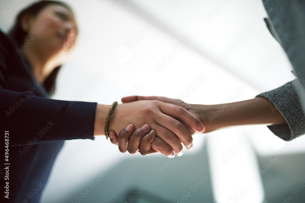 Shaking on their success. Cropped shot of two creative businesspeople shaking hands.