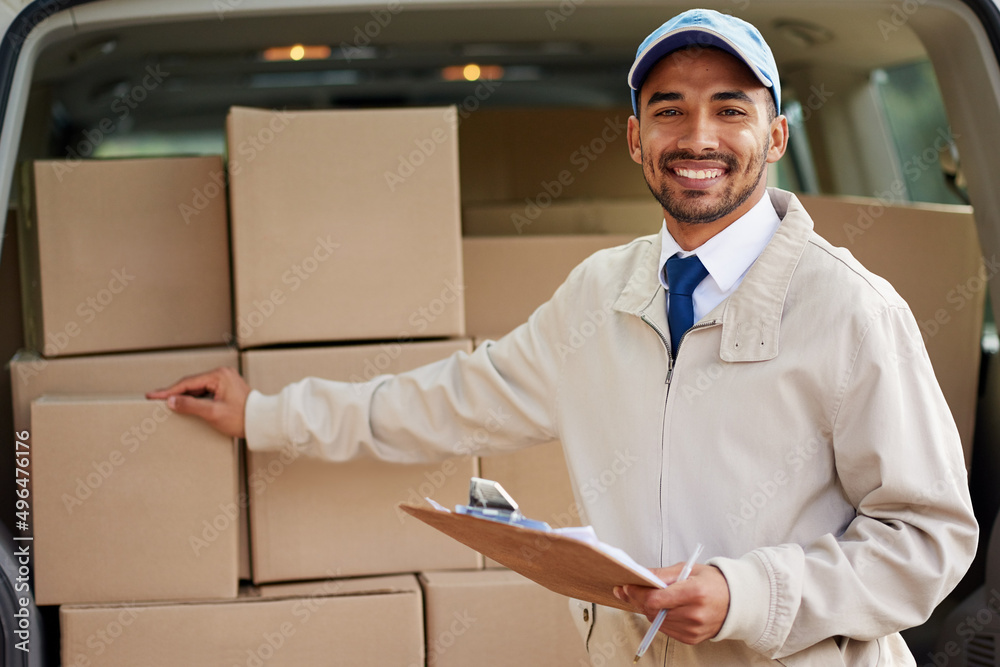 Service with a smile. Portrait of a friendly delivery man standing next to a van full of boxes.