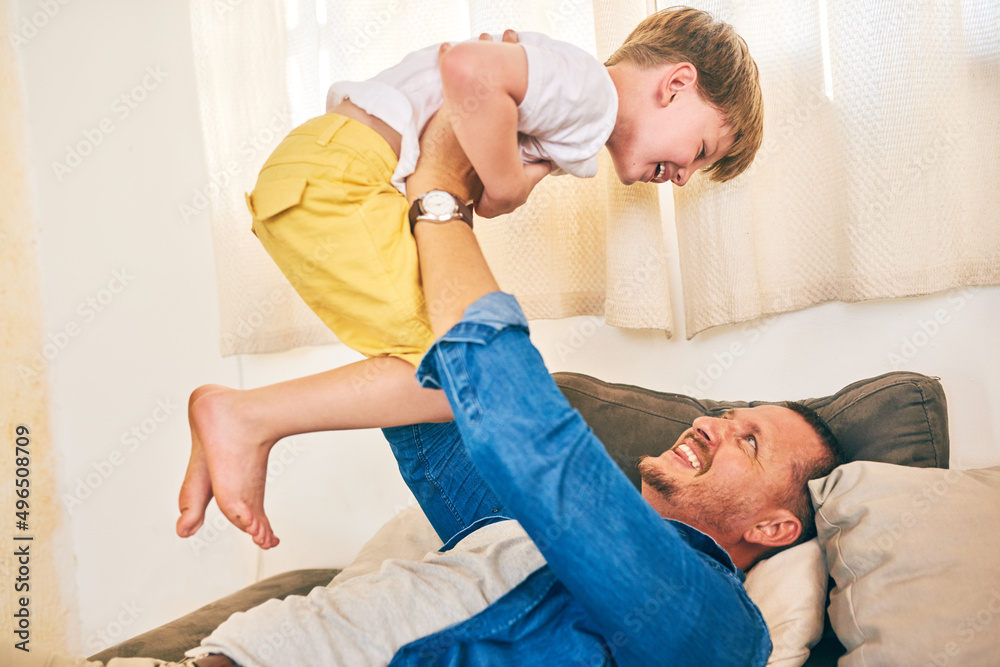 Nothing builds a bond like play time. Shot of a happy little boy having fun with his father at home.