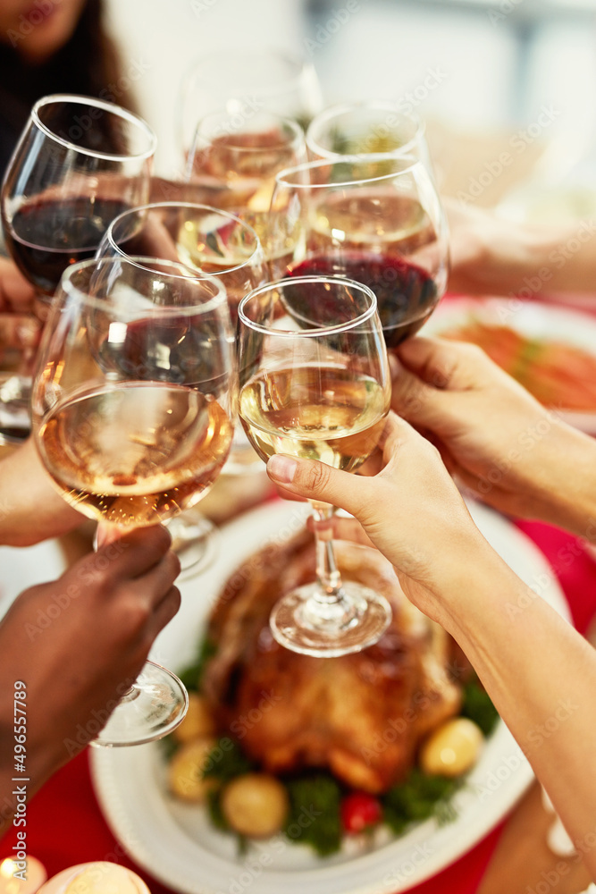 Wine pairs nicely with good friends. Cropped shot of a group of people making a toast at a dining ta